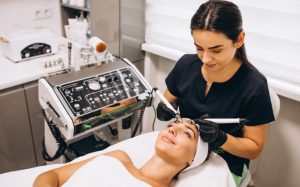 Cosmetology students practicing facial techniques in a training lab